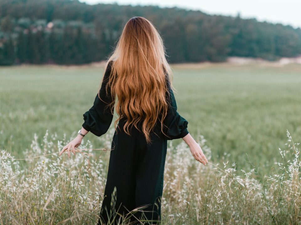 woman standing on green grass field during daytime