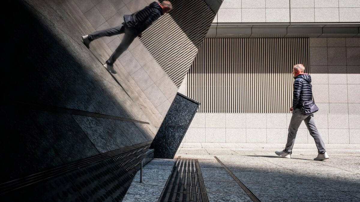 A man riding a skateboard down the side of a wall