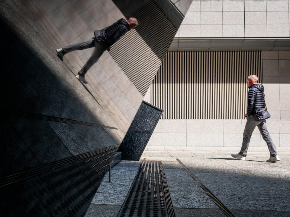 A man riding a skateboard down the side of a wall