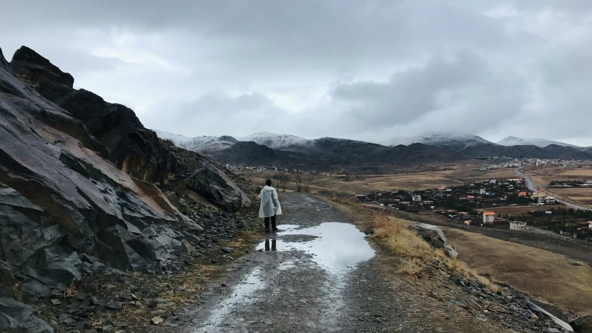 a person walking on a dirt road