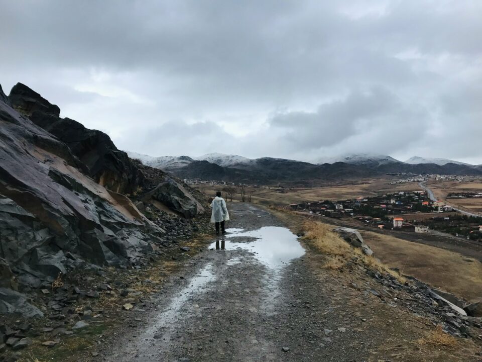 a person walking on a dirt road