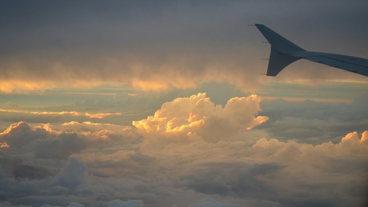 a view of the wing of an airplane in the sky