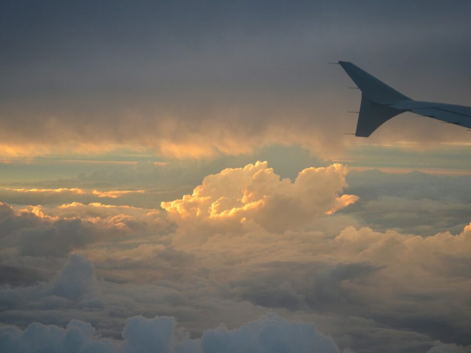 a view of the wing of an airplane in the sky