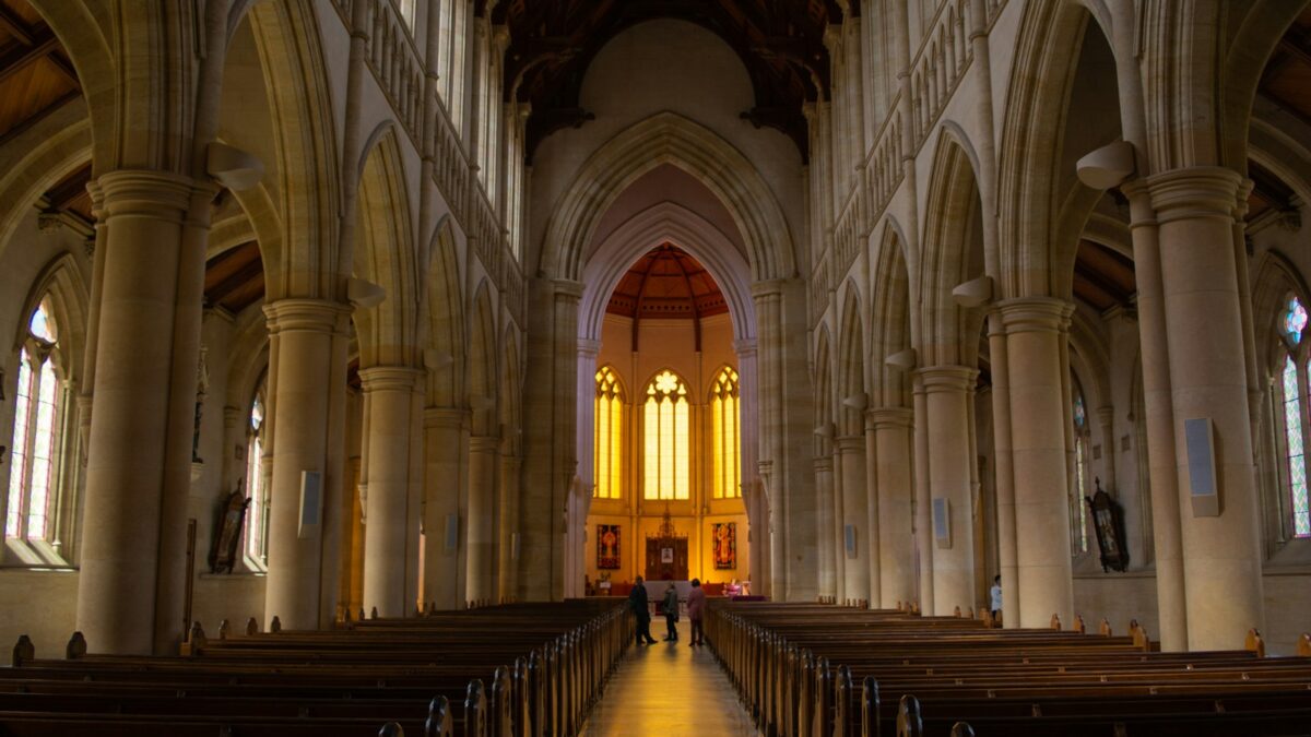 person standing inside yellow and white church