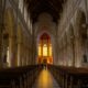 person standing inside yellow and white church