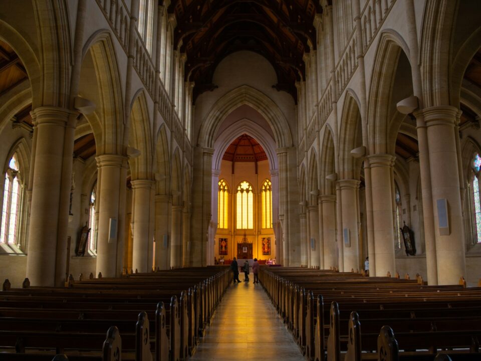 person standing inside yellow and white church