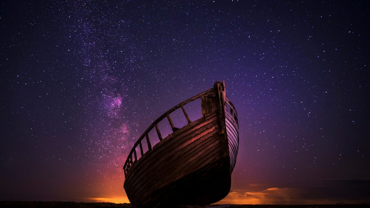 silhouette photography of sailing boat on body of water