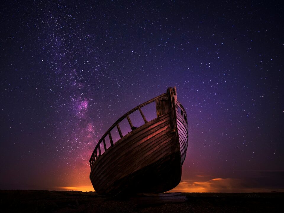 silhouette photography of sailing boat on body of water