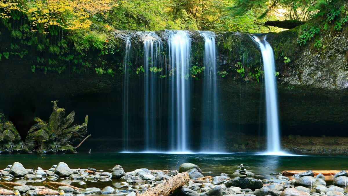 long-exposure photo of lake with waterfall at daytime