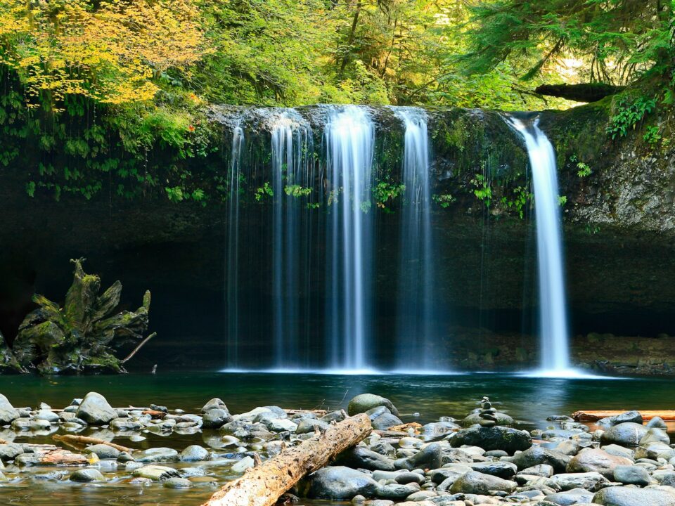 long-exposure photo of lake with waterfall at daytime