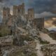a stone castle on a rocky hill under a cloudy sky