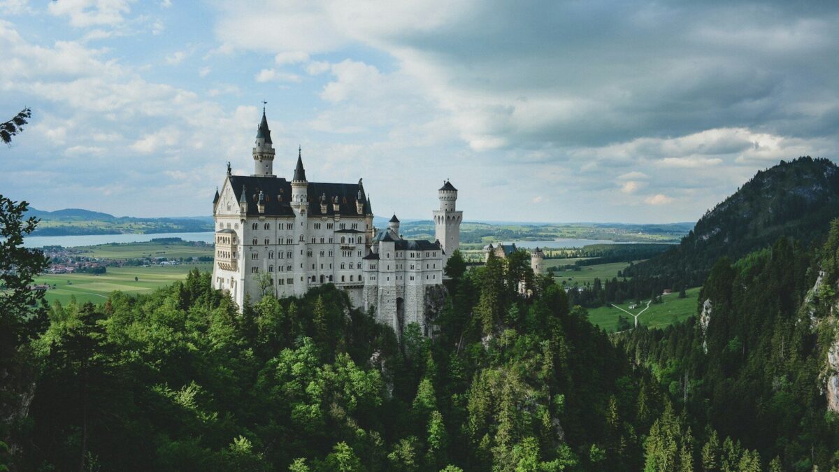 white concrete castle in green field