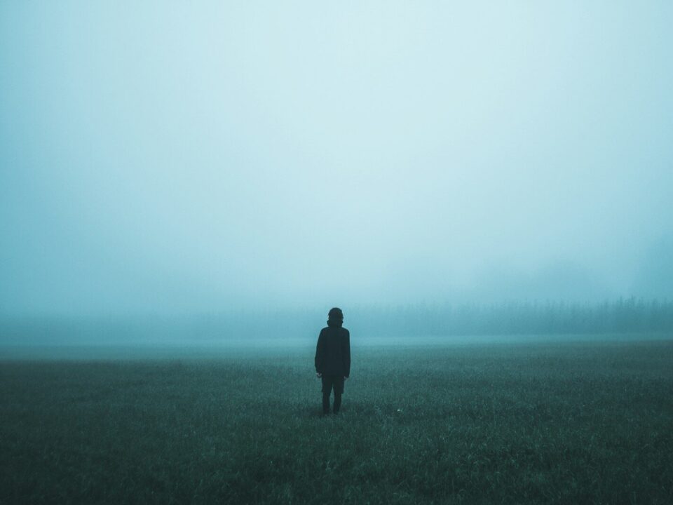person standing on misty ground