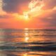 sea under white clouds at golden hour