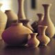 brown ceramic vases on wooden surface