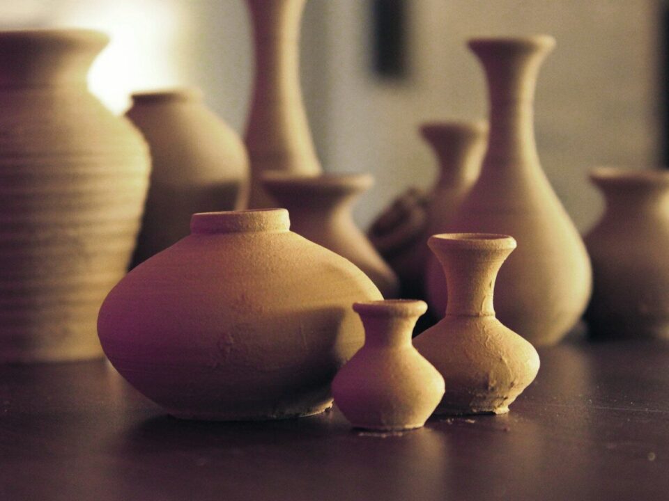 brown ceramic vases on wooden surface